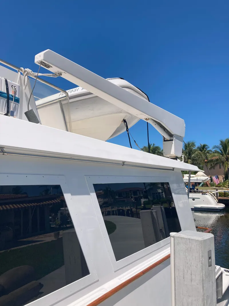Slide: The Image of 1988 Viking 70 Cockpit Motor Yacht docked under clear blue sky. - 8