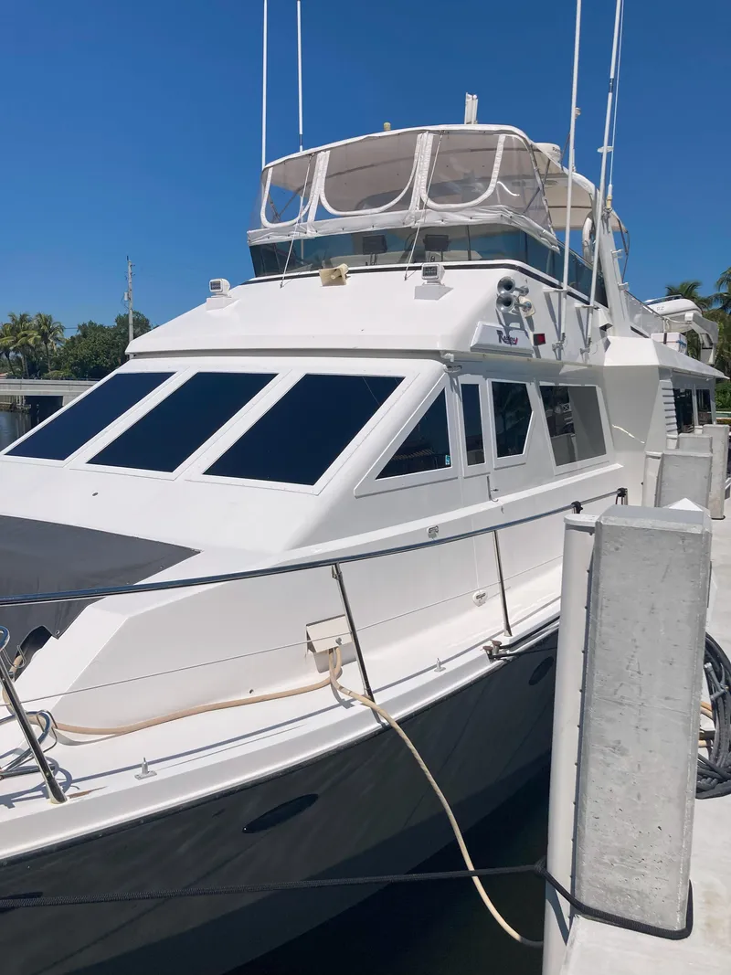 Slide: The Image of 1988 Viking 70 Cockpit Motor Yacht docked at marina. - 9