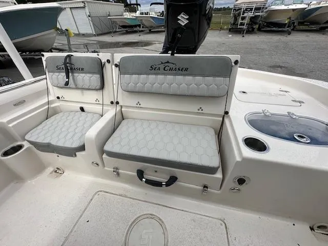 Slide: The Image of 2024 Carolina Skiff 23 LX boat interior with Sea Chaser seating and storage compartments. - 12