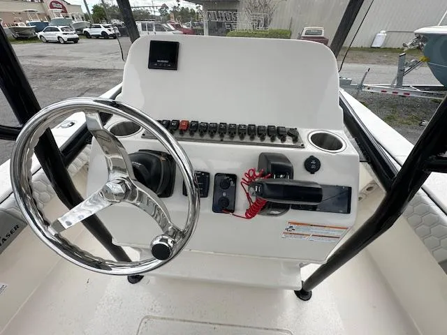 Slide: The Image of 2024 Carolina Skiff 23 LX boat console with steering wheel and control panel. - 16