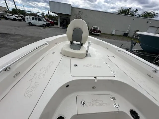 Slide: The Image of 2024 Carolina Skiff 23 LX boat deck with seating and storage compartments. - 18