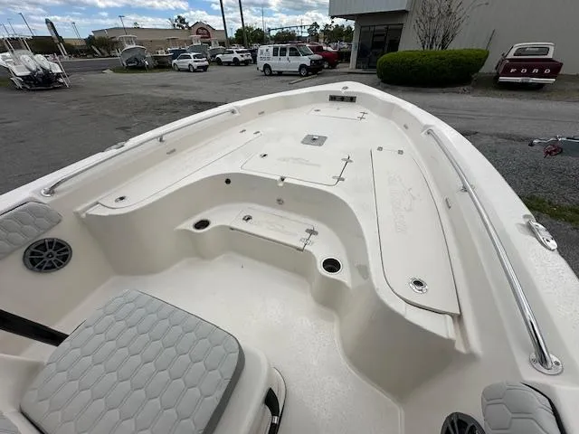 Slide: The Image of 2024 Carolina Skiff 23 LX boat interior, spacious deck with seating and storage compartments. - 22
