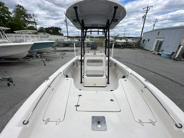 Slide: The Image of 2024 Carolina Skiff 23 LX boat, front deck view at a marina. - 7