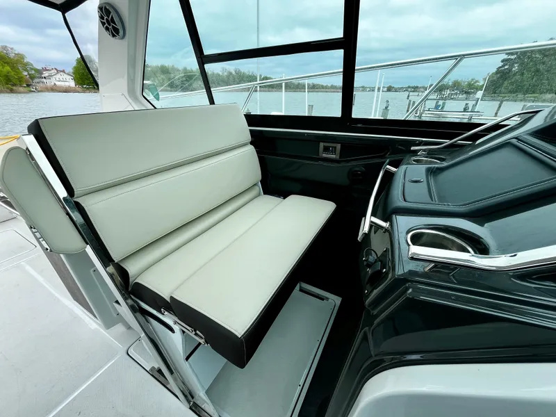 Slide: The Image of 2018 Monterey 360 Sport Coupe interior helm with white seating and water view. - 10