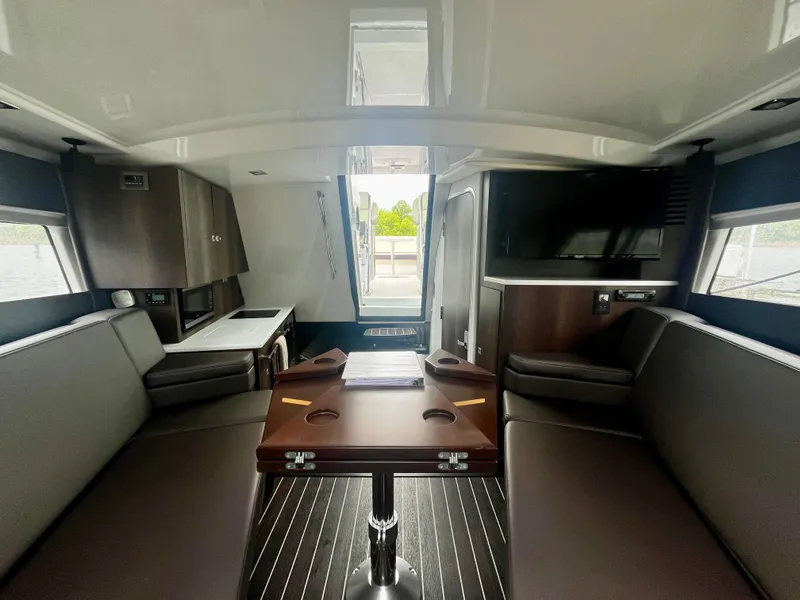 Slide: The Image of Interior of 2018 Monterey 360 Sport Coupe yacht with modern seating and entertainment area. - 16