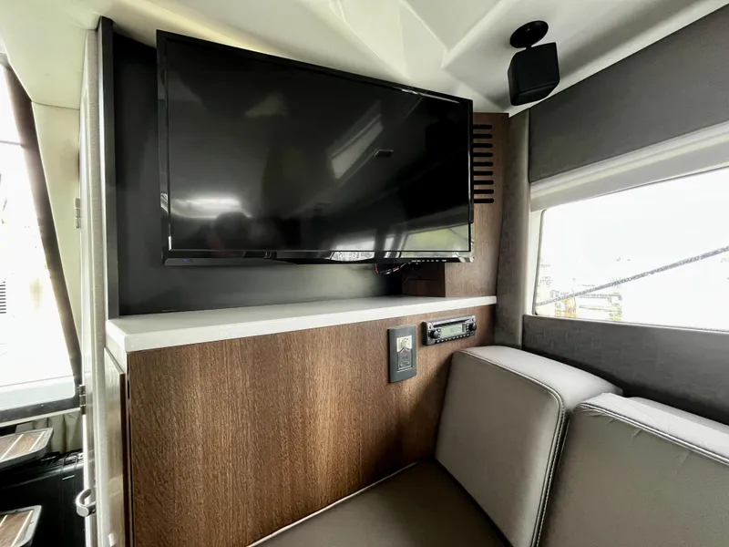 Slide: The Image of Interior of 2018 Monterey 360 Sport Coupe with mounted TV and seating area. - 17