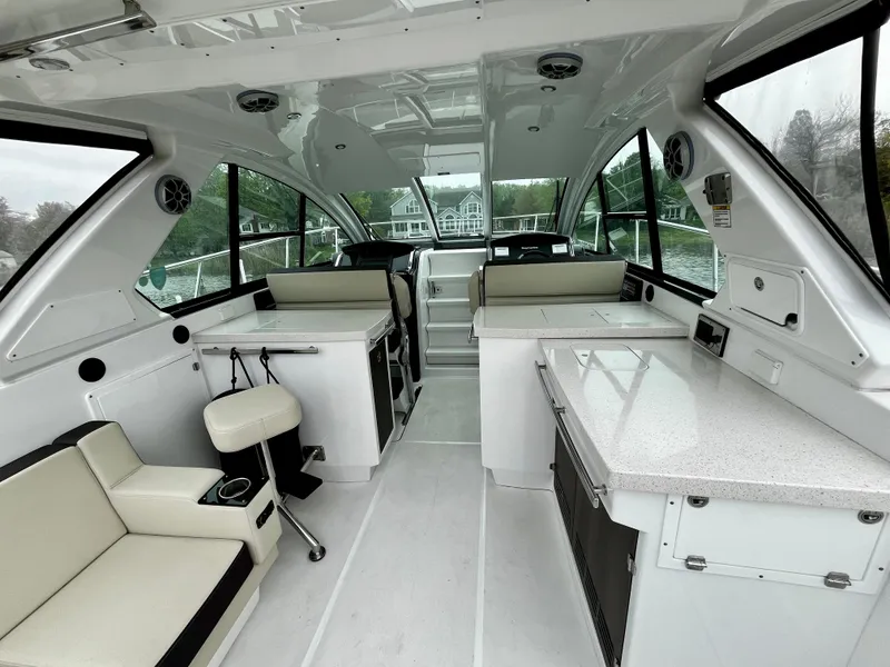 Slide: The Image of Interior of a 2018 Monterey 360 Sport Coupe luxury yacht with modern seating and kitchen area. - 5