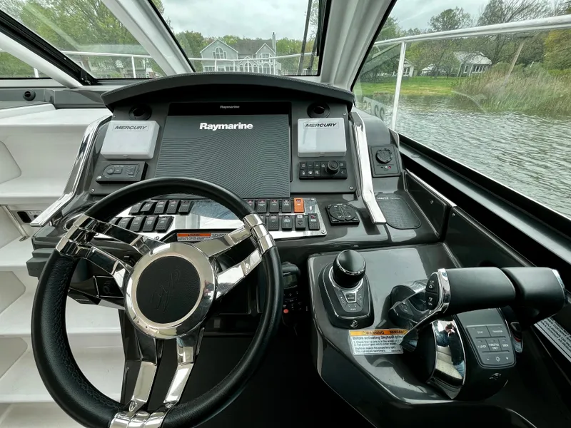 Slide: The Image of 2018 Monterey 360 Sport Coupe helm with Raymarine electronics and dual Mercury controls. - 6