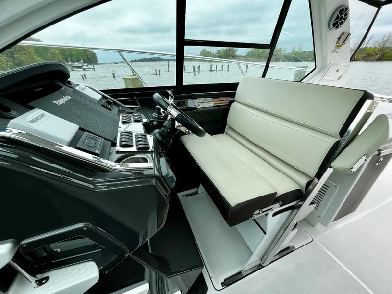 Slide: The Image of 2018 Monterey 360 Sport Coupe helm with leather seating and modern controls. - 9