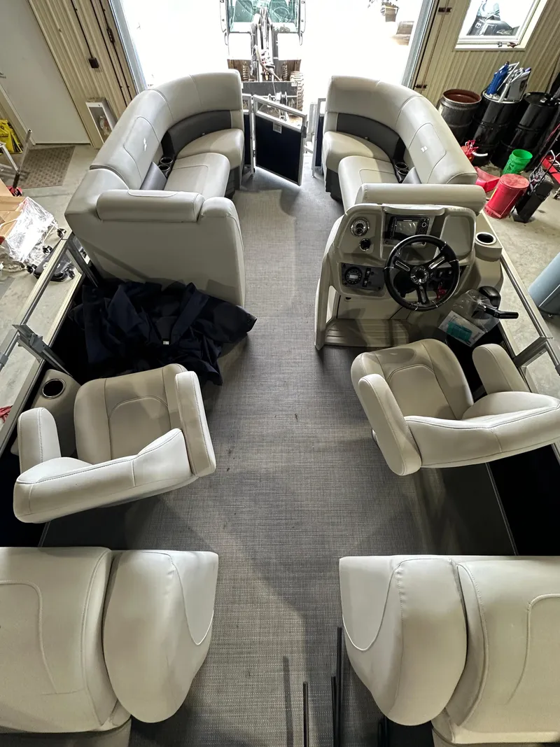 Slide: The Image of 2024 Starcraft LX22RDH pontoon boat interior with plush seating and modern helm. - 5