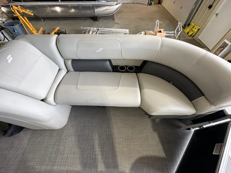 Slide: The Image of 2024 Starcraft LX22RDH pontoon boat interior seating with cup holders. - 7