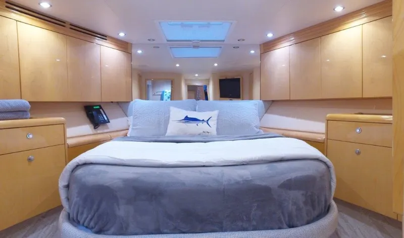 Slide: The Image of Luxurious 2006 Hatteras Enclosed Bridge yacht bedroom with modern wood cabinetry and skylight. - 12