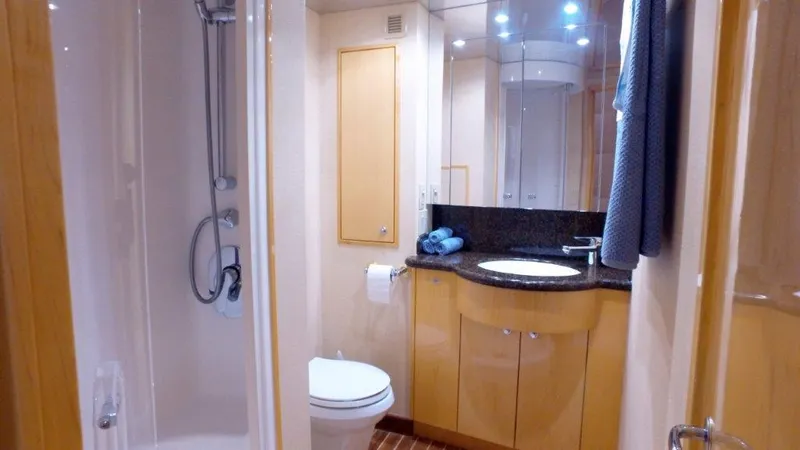 Slide: The Image of Luxurious bathroom in 2006 Hatteras Enclosed Bridge yacht with modern fixtures and elegant design. - 16