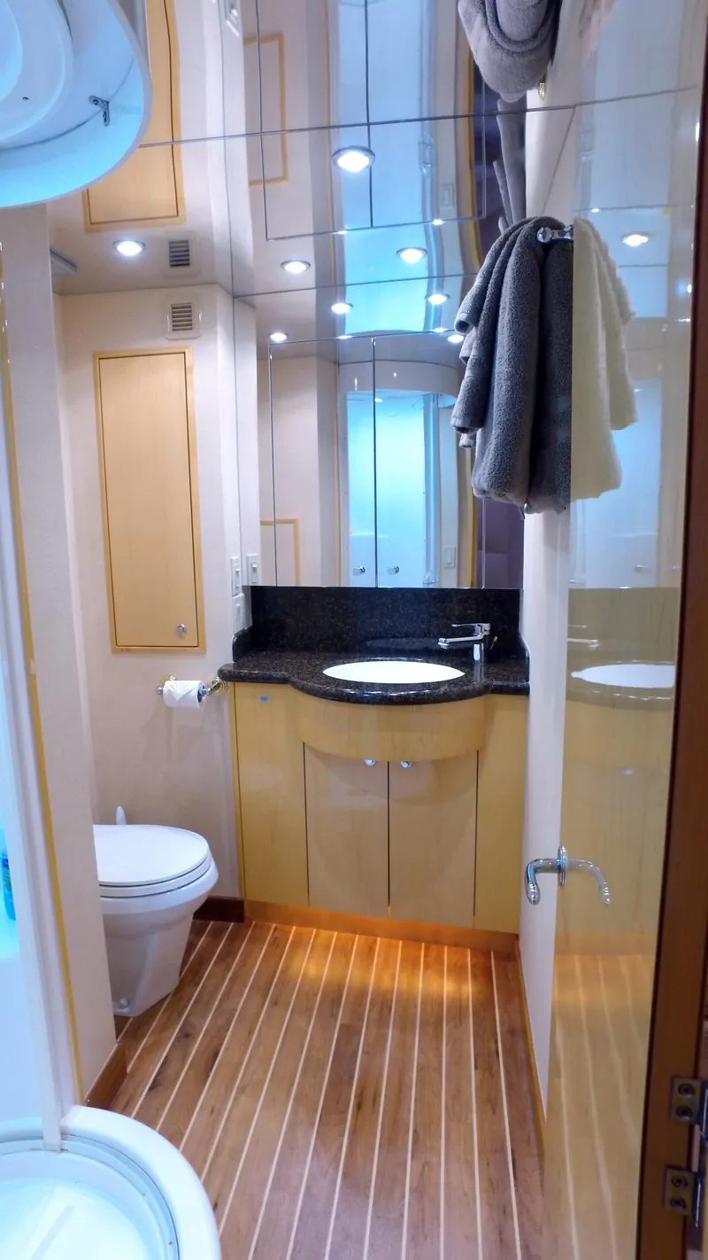 Slide: The Image of Luxurious bathroom in 2006 Hatteras Enclosed Bridge yacht with modern fixtures and wood flooring. - 19