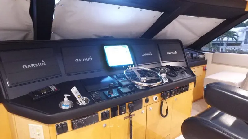 Slide: The Image of 2006 Hatteras Enclosed Bridge yacht helm with Garmin navigation system and modern controls. - 21