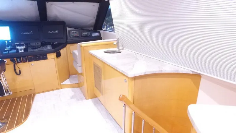 Slide: The Image of 2006 Hatteras Enclosed Bridge interior with helm, navigation equipment, and countertop sink. - 22