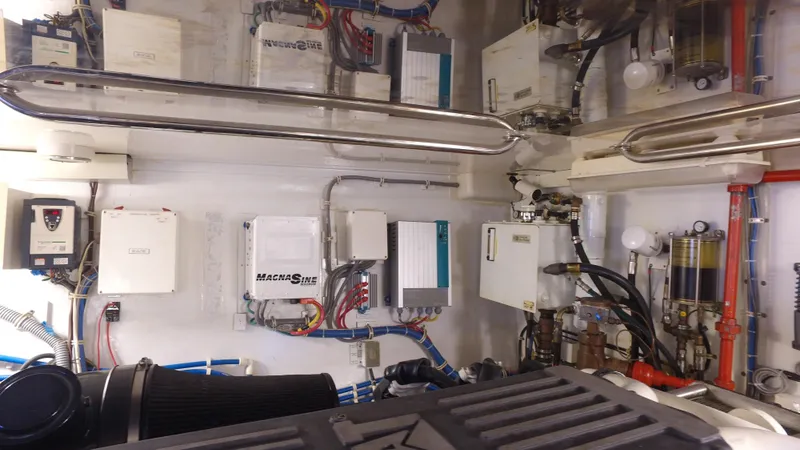 Slide: The Image of Engine room of 2006 Hatteras Enclosed Bridge yacht with various mechanical components. - 29