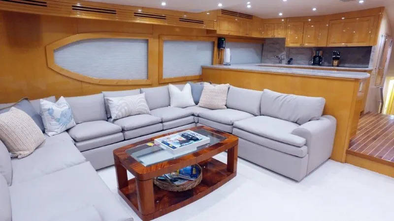 Slide: The Image of Luxurious 2006 Hatteras Enclosed Bridge yacht interior with spacious seating and modern kitchen. - 3