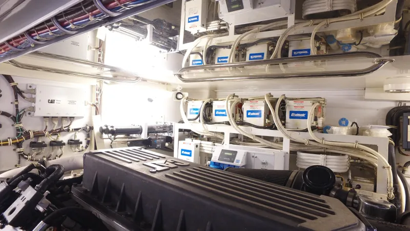 Slide: The Image of Engine room of 2006 Hatteras Enclosed Bridge yacht, showcasing mechanical systems and equipment. - 30