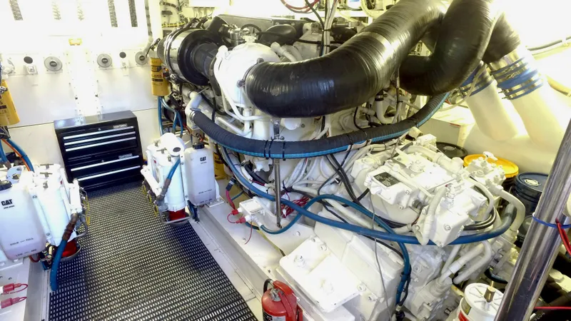 Slide: The Image of Engine room of a 2006 Hatteras Enclosed Bridge yacht, featuring complex machinery and equipment. - 32
