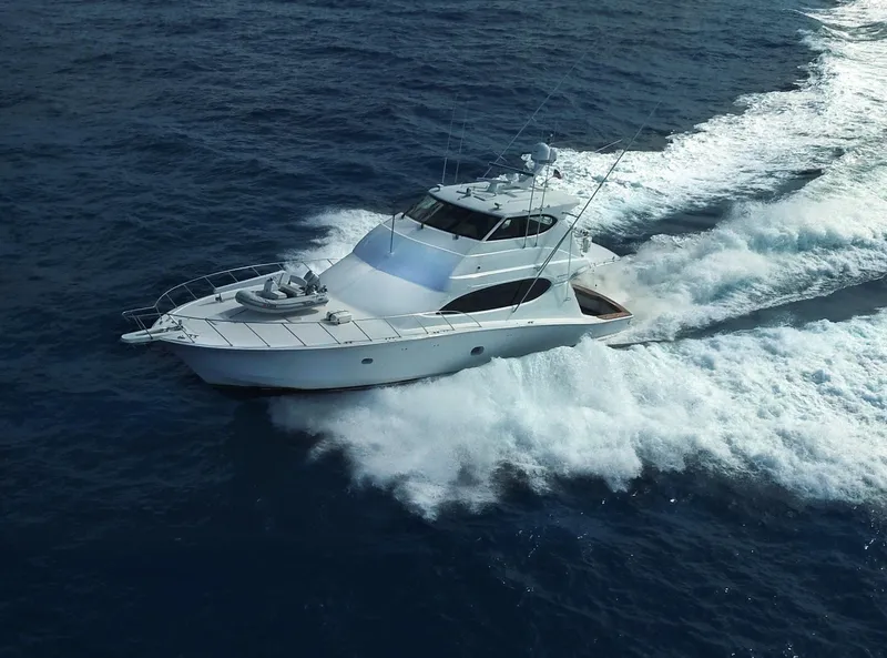 Slide: The Image of 2006 Hatteras Enclosed Bridge yacht cruising on open ocean waters. - 35