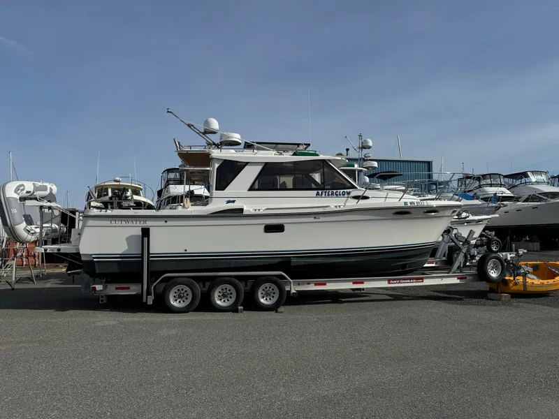 The Image of 2017 Cutwater C28 boat on a trailer in a marina setting. - 0