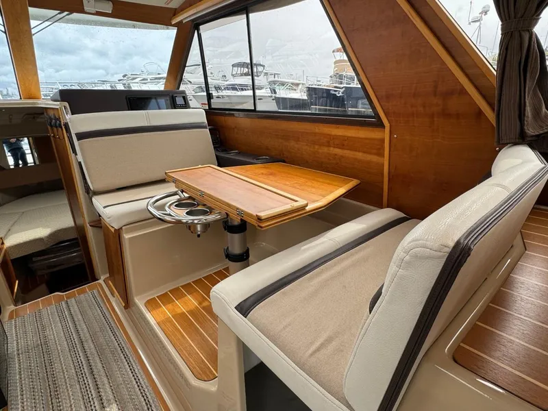 Slide: The Image of Interior of 2017 Cutwater C28 boat with wooden accents and seating area. - 12