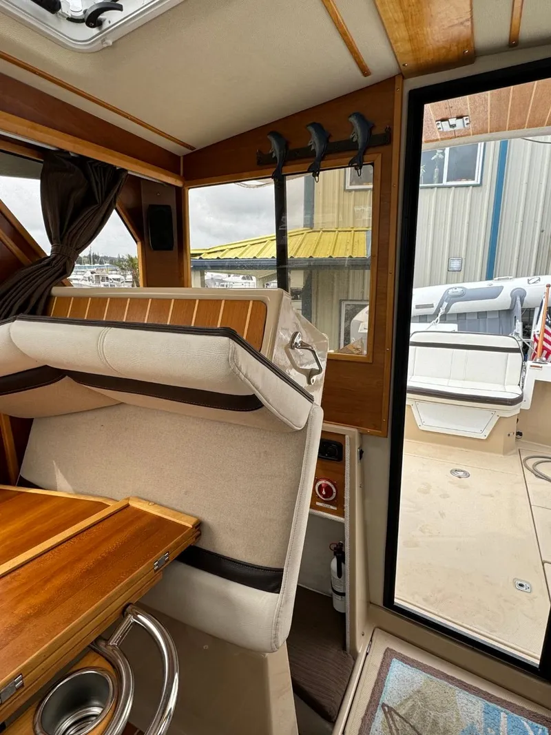 Slide: The Image of Interior of a 2017 Cutwater C28 boat with wooden accents and seating area. - 16