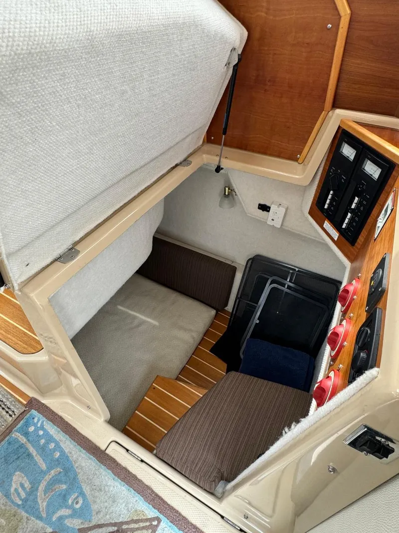 Slide: The Image of 2017 Cutwater C28 cabin interior with control panel and seating area. - 17