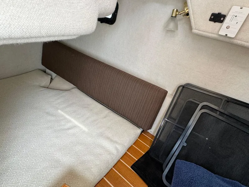 Slide: The Image of Interior cabin of a 2017 Cutwater C28 boat with bedding and storage. - 18