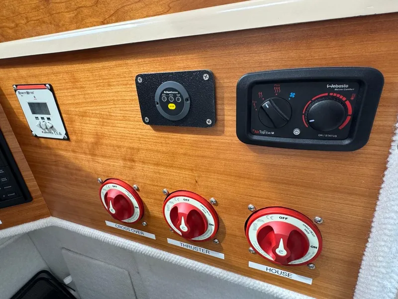 Slide: The Image of Control panel of a 2017 Cutwater C28 boat with switches and dials. - 19