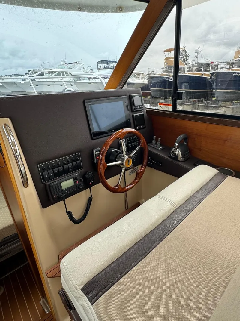 Slide: The Image of 2017 Cutwater C28 helm with wooden steering wheel and modern navigation equipment. - 21