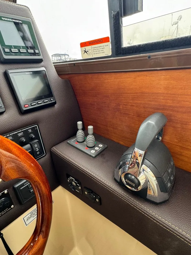 Slide: The Image of 2017 Cutwater C28 helm with controls, wooden accents, and navigation displays. - 22