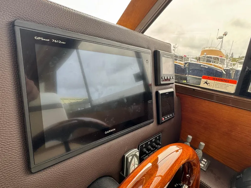 Slide: The Image of Dashboard of a 2017 Cutwater C28 boat featuring Garmin GPS and control instruments. - 23