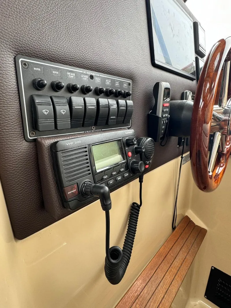 Slide: The Image of Control panel of a 2017 Cutwater C28 boat with radio and switches. - 24