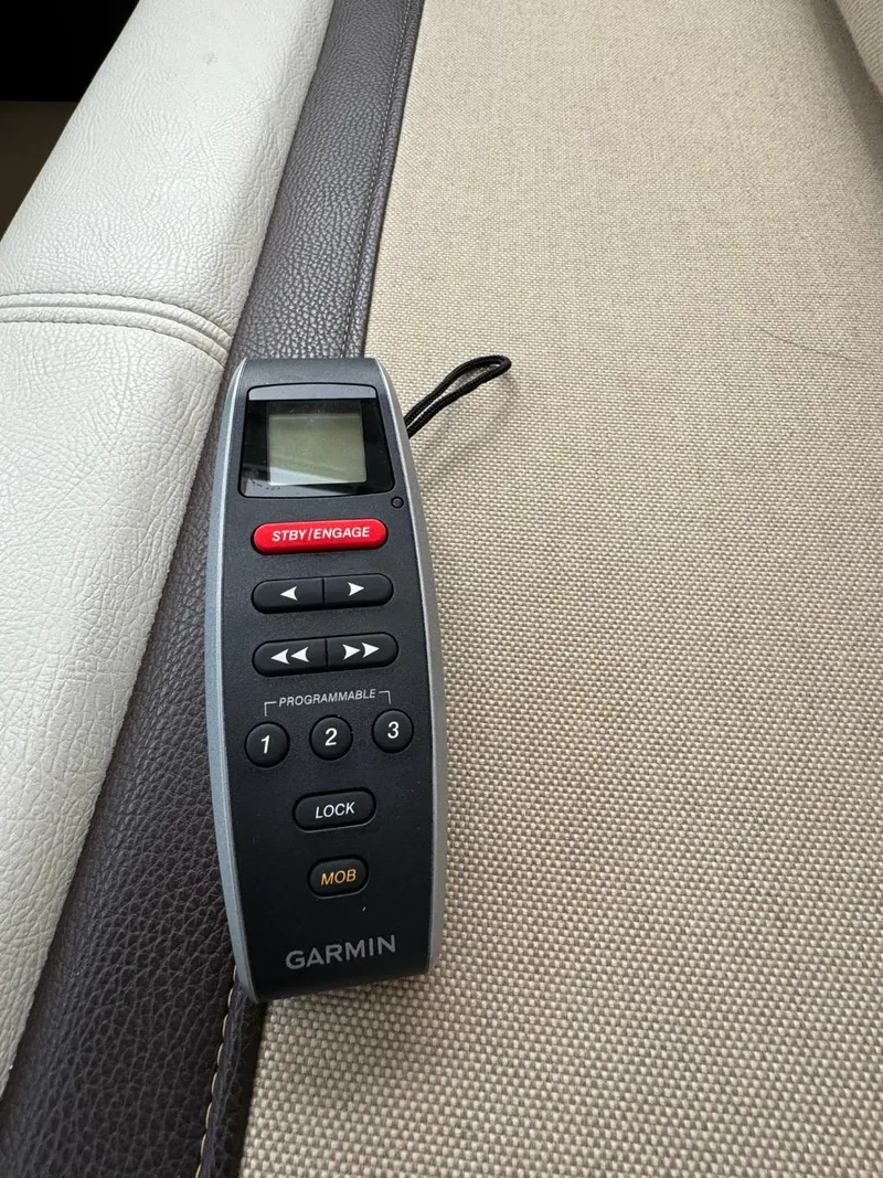 Slide: The Image of Garmin remote control on a beige and brown surface, Cutwater C28, 2017 model. - 25