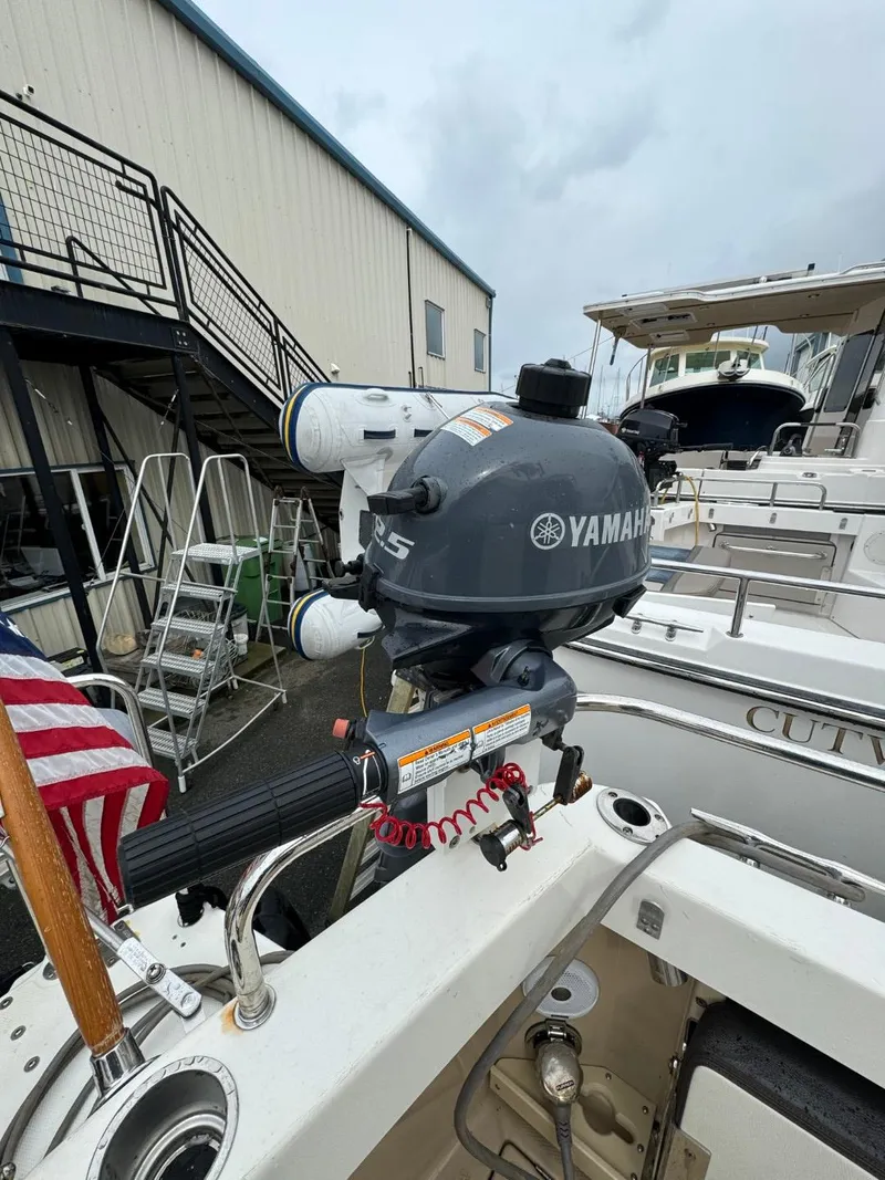 Slide: The Image of 2017 Cutwater C28 boat with Yamaha motor, docked near a building. - 3