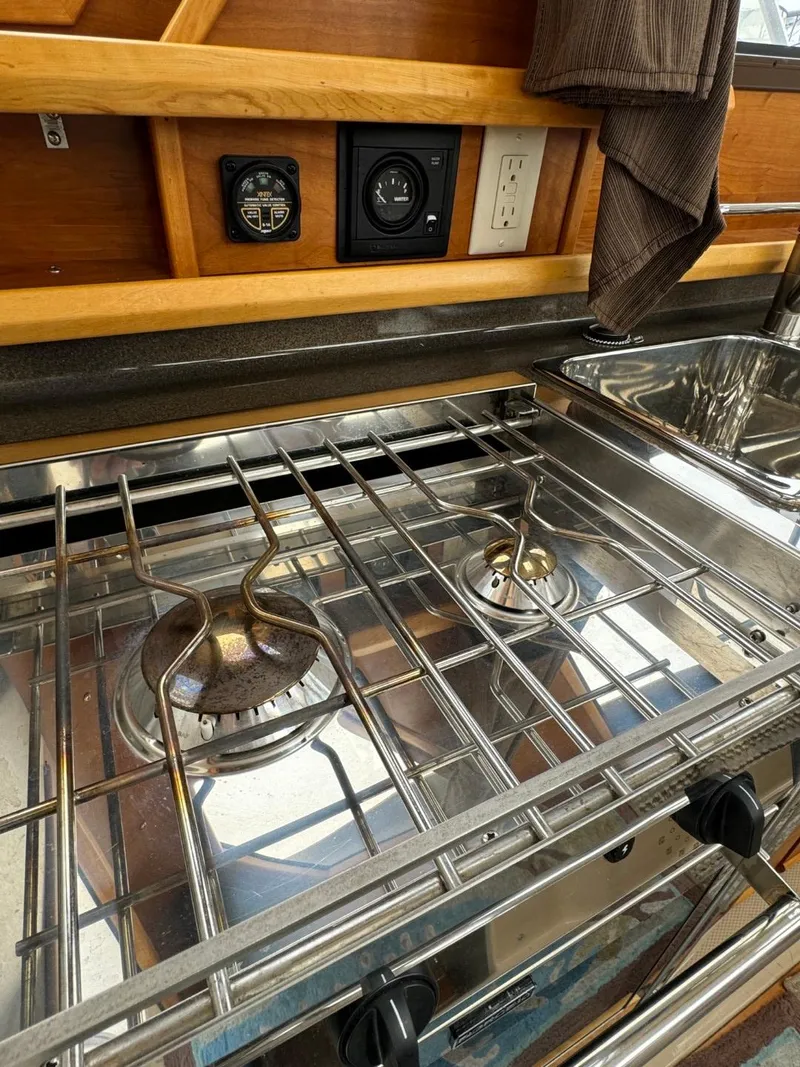 Slide: The Image of 2017 Cutwater C28 boat kitchen with stainless steel stove and sink. - 35