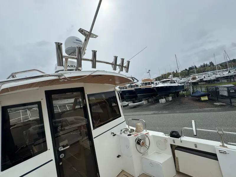 Slide: The Image of 2017 Cutwater C28 boat docked at marina with overcast sky. - 6