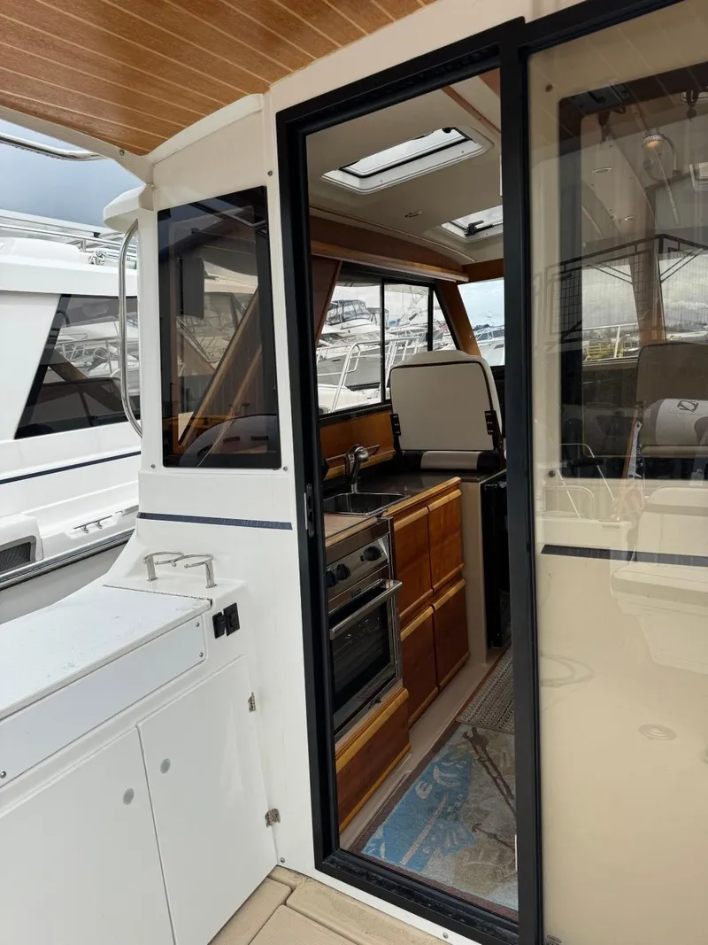 Slide: The Image of 2017 Cutwater C28 boat interior with wooden cabinetry and modern appliances. - 8