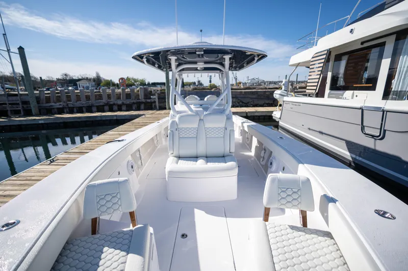 Slide: The Image of 2024 Jupiter 32 boat with luxurious seating docked at a marina. - 12