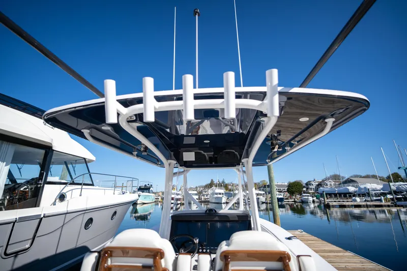Slide: The Image of 2024 Jupiter 32 boat docked at a marina, clear blue sky background. - 16