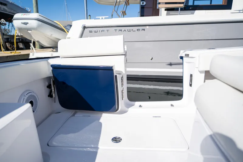 Slide: The Image of 2024 Jupiter 32 boat interior with Swift Trawler branding, featuring seating and storage compartments. - 18