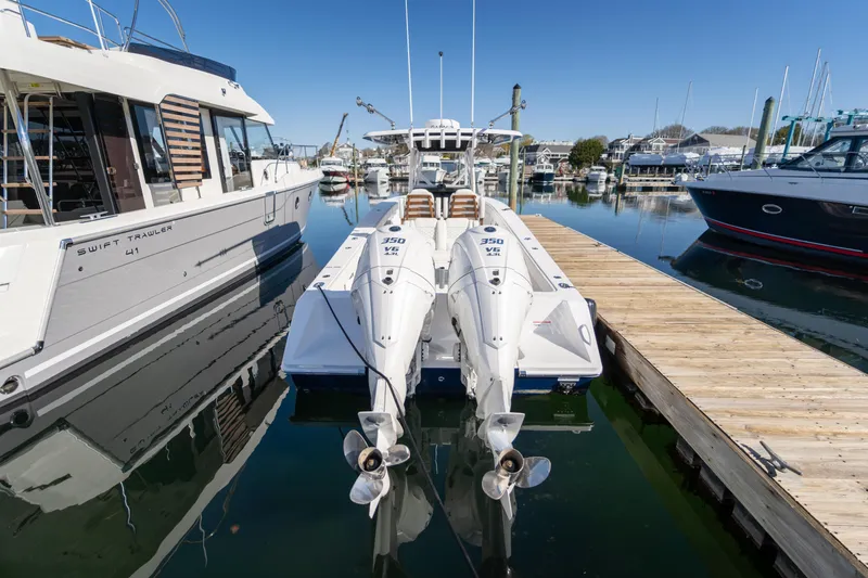 Slide: The Image of 2024 Jupiter 32 boat docked with twin outboard engines. - 2