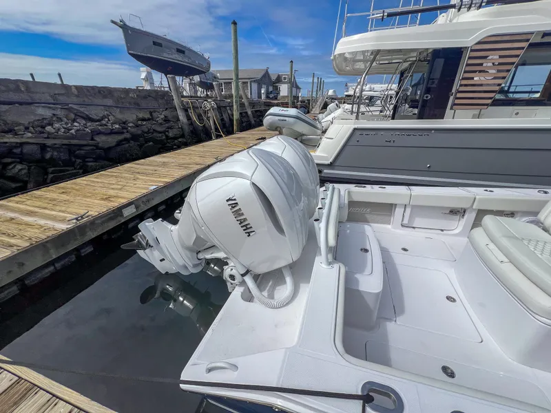 Slide: The Image of 2024 Jupiter 32 boat with Yamaha outboard engine docked at marina. - 3