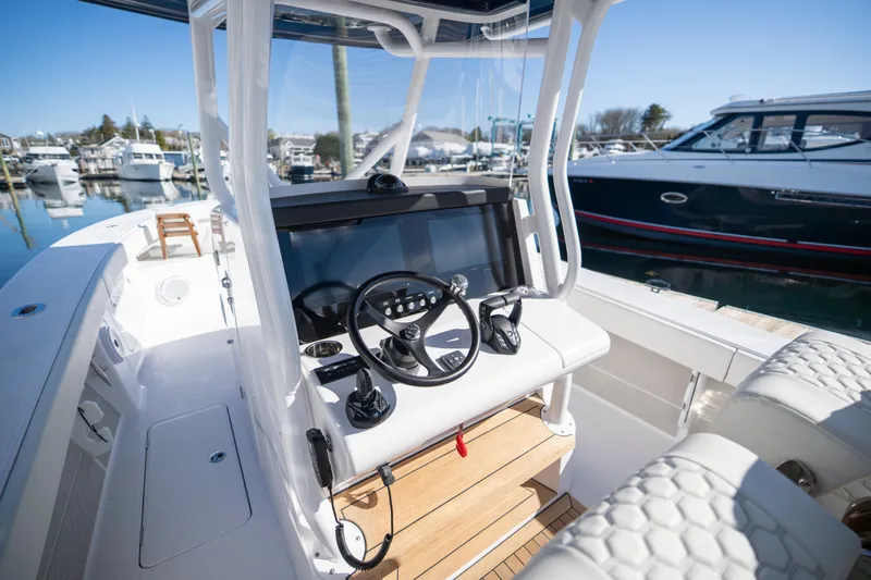Slide: The Image of 2024 Jupiter 32 boat helm with modern controls and marina background. - 4