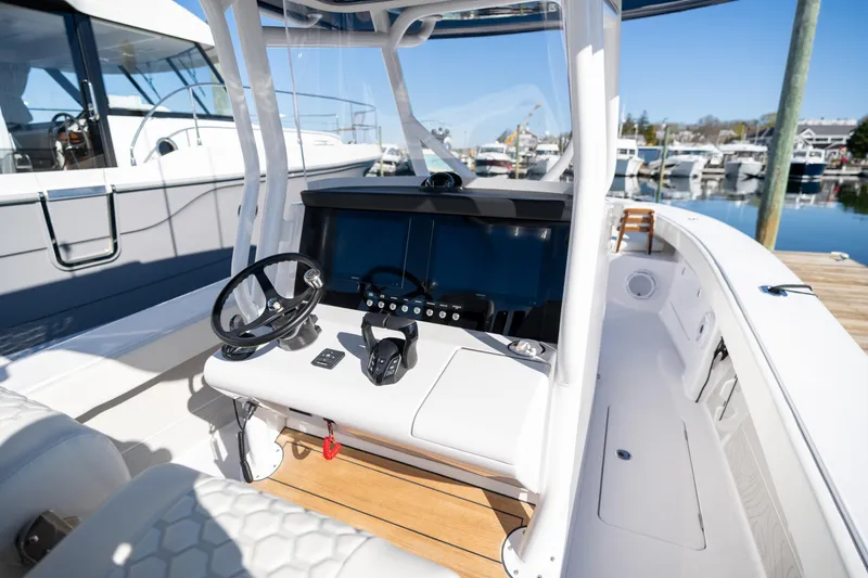 Slide: The Image of 2024 Jupiter 32 boat cockpit with modern steering and navigation system. - 6