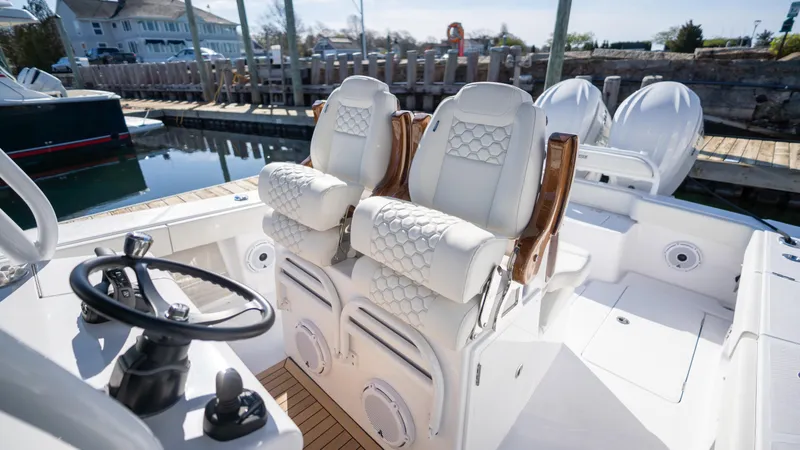 Slide: The Image of 2024 Jupiter 32 boat interior with luxurious seating and steering wheel. - 7
