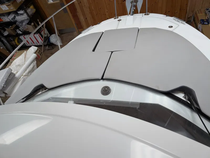 Slide: The Image of 2024 Jeanneau NC795 S2 boat deck with cushioned seating area. - 11