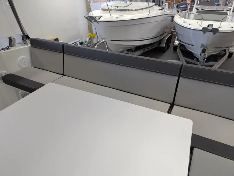 Slide: The Image of 2024 Jeanneau NC795 S2 boat interior with seating and table, showcasing modern design. - 3